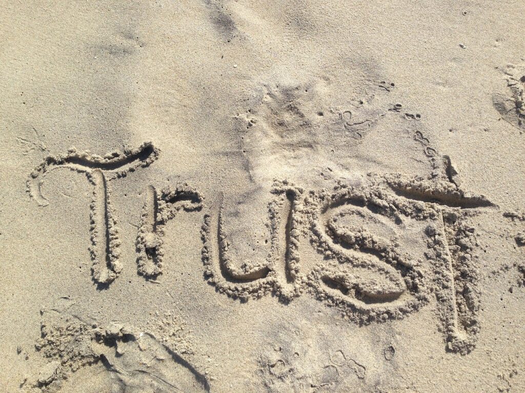 "trust" written in the sand